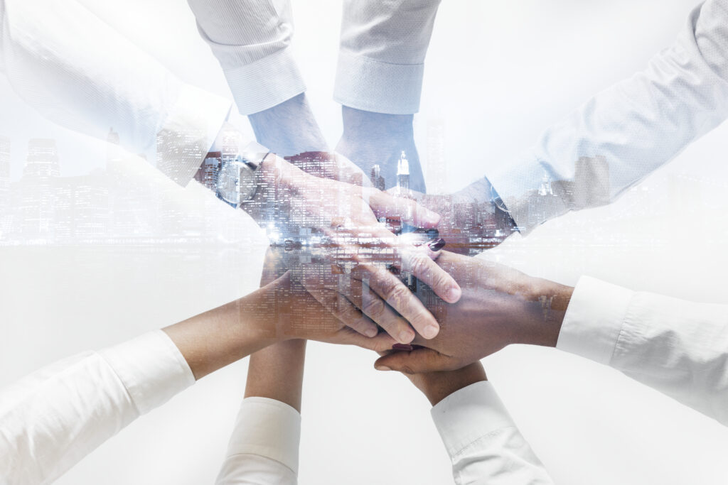 Business Team Joining Hands Together City Background 1024x683